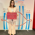 Giulia Nero shows her award certificate