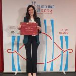 Elena Pagetti shows her award certificate
